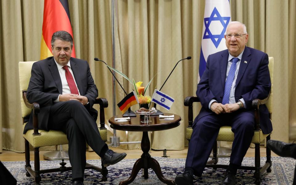 Sigmar Gabriel, left, was able to go on with meeting Israeli president Reuven Rivlin, right.  - Credit: EPA/ABIR SULTAN