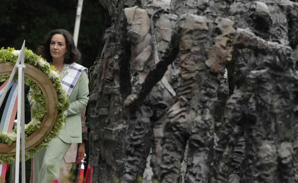Mayor Femke Halsema lays a wreath at the National Slavery Monument after apologizing for the involvement of the city's rulers in the slave trade during a nationally televised annual ceremony in Amsterdam, Netherlands, Thursday, July 1, 2021, marking the abolition of slavery in its colonies in Suriname and the Dutch Antilles on July 1, 1863. The anniversary is now known as Keti Koti, which means Chains Broken. Debate about Amsterdam's involvement in the slave trade has been going on for years and gained attention last year amid the global reckoning with racial injustice that followed the death of George Floyd in Minneapolis last year. (AP Photo/Peter Dejong)