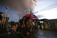 Residents evacuate as Taal Volcano erupts Sunday Jan. 12, 2020, in Tagaytay, Cavite province, outside Manila, Philippines. (AP Photo/Aaron Favila)