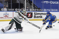 St. Louis Blues' Justin Faulk (72) attempts to block a pass from Minnesota Wild's Cam Talbot (33) during overtime of an NHL hockey game on Saturday, April 10, 2021, in St. Louis. (AP Photo/Joe Puetz)