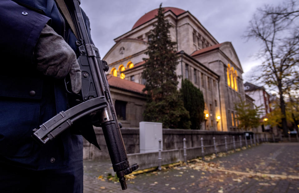 A German police officer stands guard in front of the synagogue in Frankfurt, Germany, early Wednesday, Nov. 8, 2023. Antisemitism is spiking across Europe after Hamas' Oct. 7 massacre and Israel's bombardment of Gaza, worrying Jews from London to Geneva and Berlin. (AP Photo/Michael Probst)
