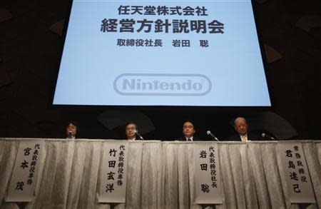 Nintendo Co Ltd President Satoru Iwata (2nd R) and the company's senior members attend at their strategy briefing in Tokyo January 30, 2014. REUTERS/Yuya Shino