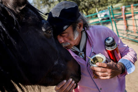 Fernando Noailles, emotional therapist, kisses his horse named Madrid in Guadalix de la Sierra, outside Madrid, Spain, April 27, 2018. REUTERS/Juan Medina