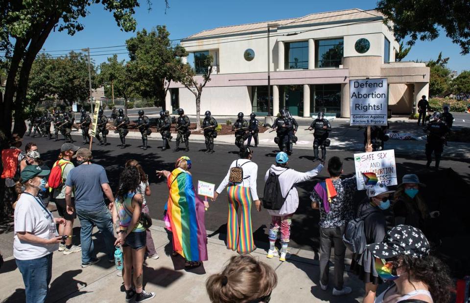 Sheriff’s deputies and Modesto Police try and clear the area around the Planned Parenthood office on McHenry Ave during an opposition rally that began as a protest to the Straight Pride event in Modesto, Calif., on Saturday, August 27, 2022.