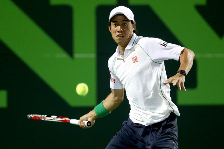 Kei Nishikori of Japan returns a shot to Roger Federer during the Sony Open at the Crandon Park Tennis Center on March 26, 2014 in Key Biscayne, Florida