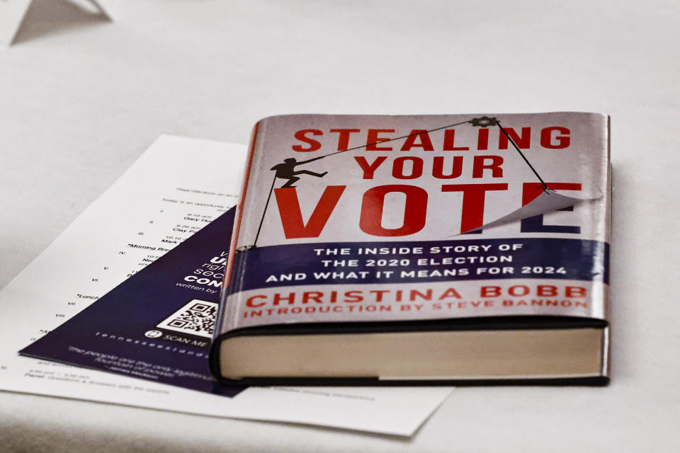 A book about the inside story of the 2020 election lays on a table during an Election Conspiracy Forum Saturday, March 11, 2023, in Franklin, Tenn. (AP Photo/Wade Payne)