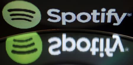 FILE PHOTO: The logo of online music streaming service Spotify is reflected in an audio music CD in this illustration picture taken in Strasbourg, February 18, 2014. REUTERS/Vincent Kessler