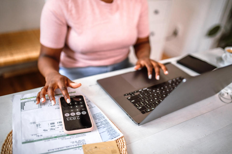 A woman using the calculator on her phone