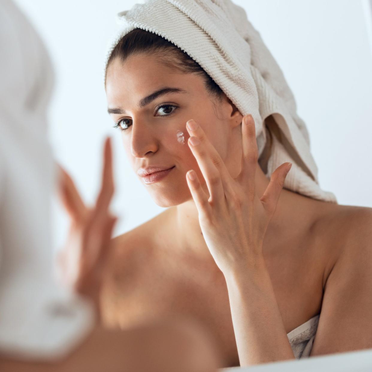  woman applying sulfur spot treatment to acne 