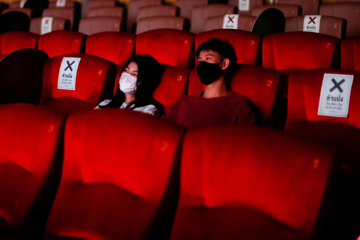 People wearing protective face masks are seen inside a movie theater during its reopening after the Thai government eased isolation measures to prevent the spread of the coronavirus disease (COVID-19) in Bangkok, Thailand, June 1, 2020. REUTERS/Jorge Silva     TPX IMAGES OF THE DAY