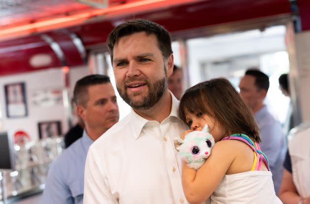 Republican vice presidential nominee Senator JD Vance (Ohio) carries his daughter Maribel as he greets supporters at the Park Diner on July 28, 2024 in St. Louis.