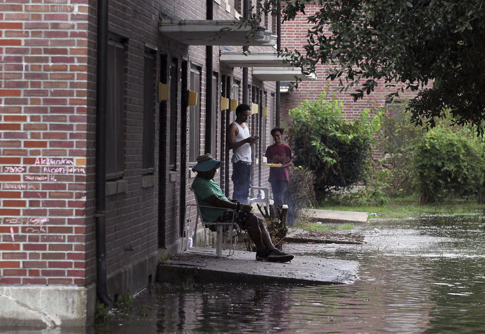 Residents at Trent Court Apartments wait out the weather as rising waters get closer to their doors in New Bern on Thursday.