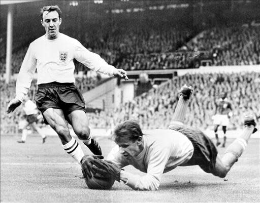 (FILES) - Russian goalkeeper Lev Yachine dives to catch the ball in front of English forward Greaves during the friendly match between England and a "Rest of the World" selection 24 October 1963 at Wembley stadium in London. England won 2-1