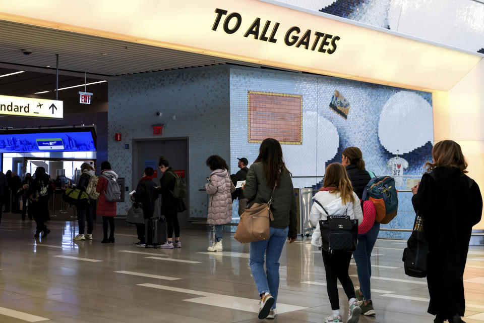 Traveler walk towards the TSA screening area in LaGuardia Airport's Terminal B, Tuesday, Nov. 22, 2022, in New York. Travel experts say the ability of many people to work remotely is letting them take off early for Thanksgiving or return home later. Crowds are expected to rival those of 2019, the last Thanksgiving before the pandemic. (AP Photo/Julia Nikhinson)