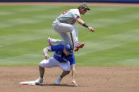 Philadelphia Phillies shortstop Nick Maton, top, jumps over Toronto Blue Jays' Randal Grichuk to complete a throw for a double play against Blue Jays' Rowdy Tellez during the first inning of a baseball game Sunday, May 16, 2021, in Dunedin, Fla. (AP Photo/Mike Carlson)