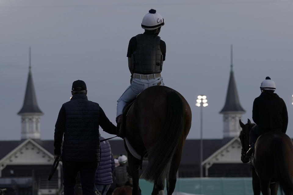 A horse is led onto the track for a workout at Churchill Downs Thursday, May 5, 2022, in Louisville, Ky. The 148th running of the Kentucky Derby is scheduled for Saturday, May 7. (AP Photo/Charlie Riedel)