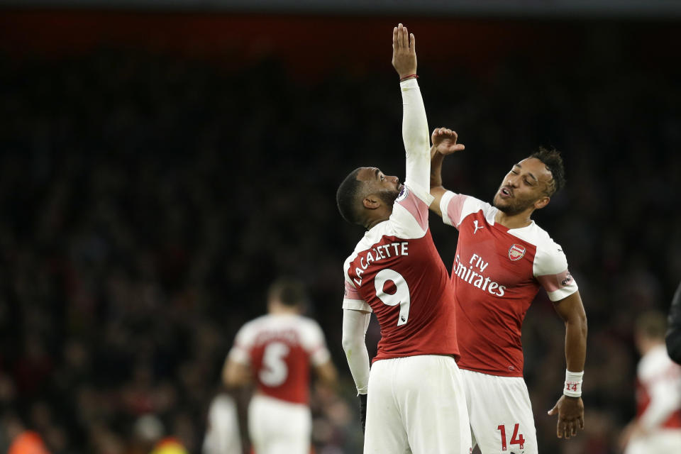 Arsenal's Pierre-Emerick Aubameyang, right, and Arsenal's Alexandre Lacazette celebrate at the end of the English Premier League soccer match between Arsenal and Tottenham Hotspur at the Emirates Stadium in London, Sunday Dec. 2, 2018. (AP Photo/Tim Ireland)