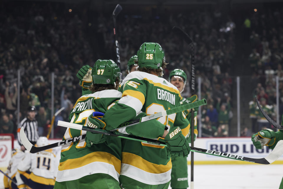 Minnesota Wild defenseman Jonas Brodin (25) celebrates with teammates after scoring against the Nashville Predators during the first period of an NHL hockey game Sunday, March 10, 2024, in St. Paul, Minn. (AP Photo/Stacy Bengs)