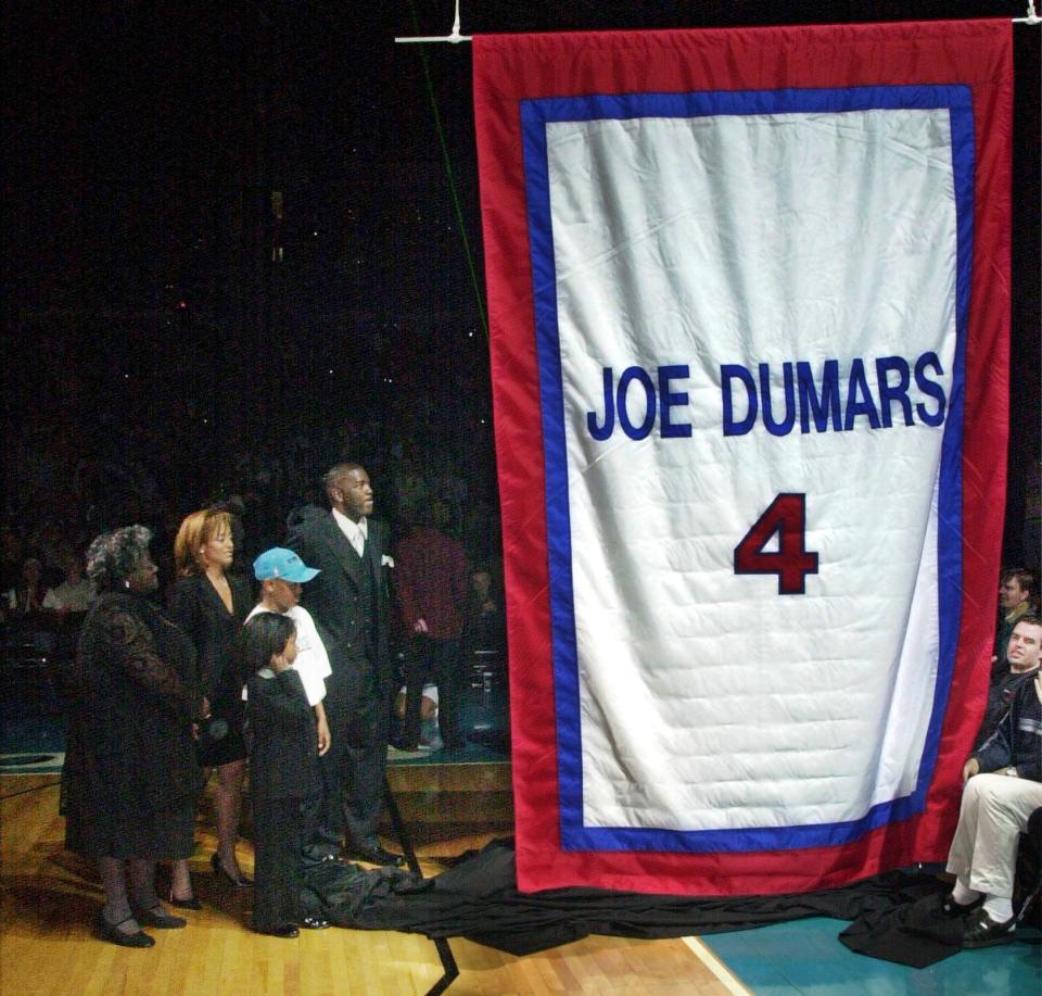 AUBURN HILLS, UNITED STATES:  Former Detroit Pistons Joe Dumars and his family watch a banner being raised at a ceremony where the Pistons retired his number 10 March 2000 at the Palace of Auburn Hills, Michigan.  The NBA announced their annual Sportsmanship Award will bear Dumars' name.  Dumars played 14 seasons in the NBA and was the MVP in the 1989 NBA finals. (ELECTRONIC IMAGE)   AFP PHOTO/Jeff KOWALSKY (Photo credit should read JEFF KOWALSKY/AFP via Getty Images)