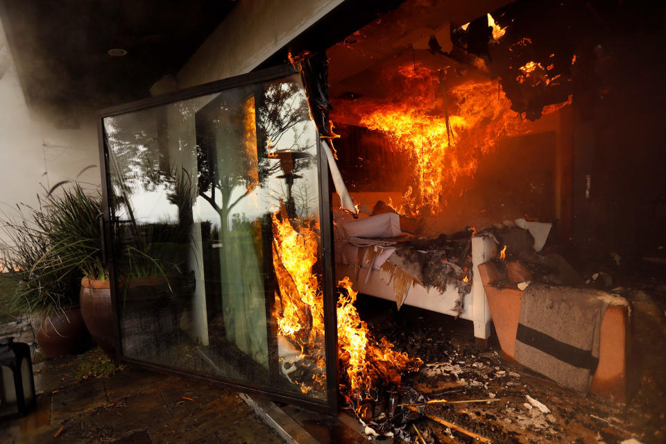 <p>The bedroom of a home is engulfed in flames from the Skirball fire along on December 6 in Bel-Air, California.</p>