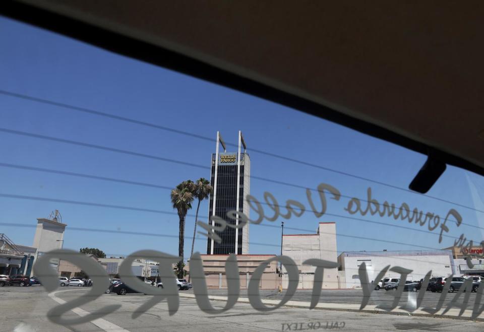 The Wells Fargo Bank building stands by two palm trees.