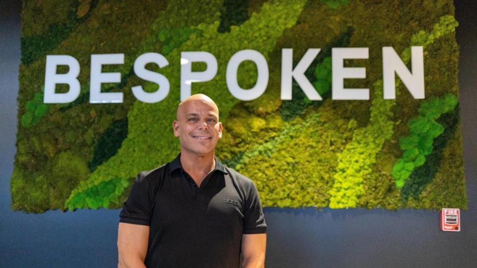 Bespoken Spirits CEO Peter Iglesias poses in front of the moss wall sign within the distillery’s tasting room In Greyline Station on West Loudon Avenue, March 20, 2024.