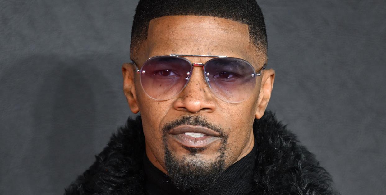jamie foxx wearing black tinted sunglasses, a black turtleneck sweater, and a black fur coat at the creed 3 premiere in february 2023