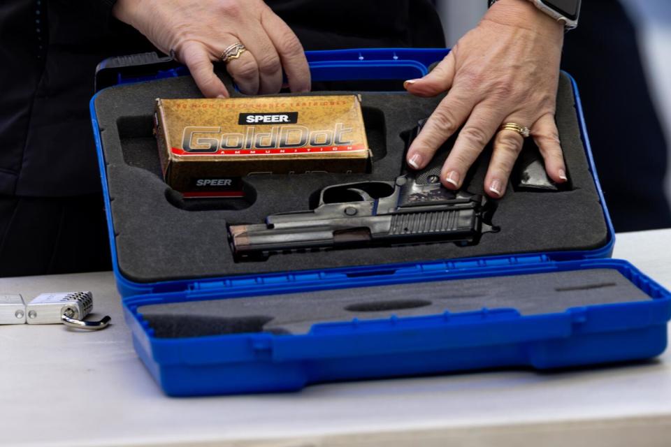 TSA spokesperson Lorie Dankers demonstrates how to lock a gun in a case accepted by TSA for checked-in luggage.