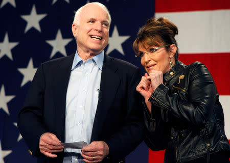 U.S. Senator John McCain (R-AZ) and former Alaska Governor and vice presidential candidate Sarah Palin acknowledge the crowd during a campaign rally for McCain at the Pima County Fairgrounds in Tucson, Arizona March 26, 2010. REUTERS/Joshua Lott/Files