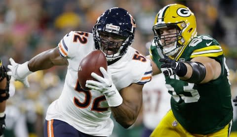 Chicago Bears' Khalil Mack intercepts a pass and returns it for a touchdown during the first half of an NFL football game against the Green Bay Packers, in Green Bay, Wis. The Chicago Bears have a chance to tighten their grip on the NFC North lead and show just how far they have come when they host the defending division champion Vikings in primetime showdown for first place on Sunday - Credit: AP Photo/Jeffrey Phelps