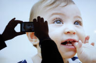 A show attendee photographs an image displayed on Sony's 84-inch XBR 4K LED television after a news conference at the International Consumer Electronics Show.