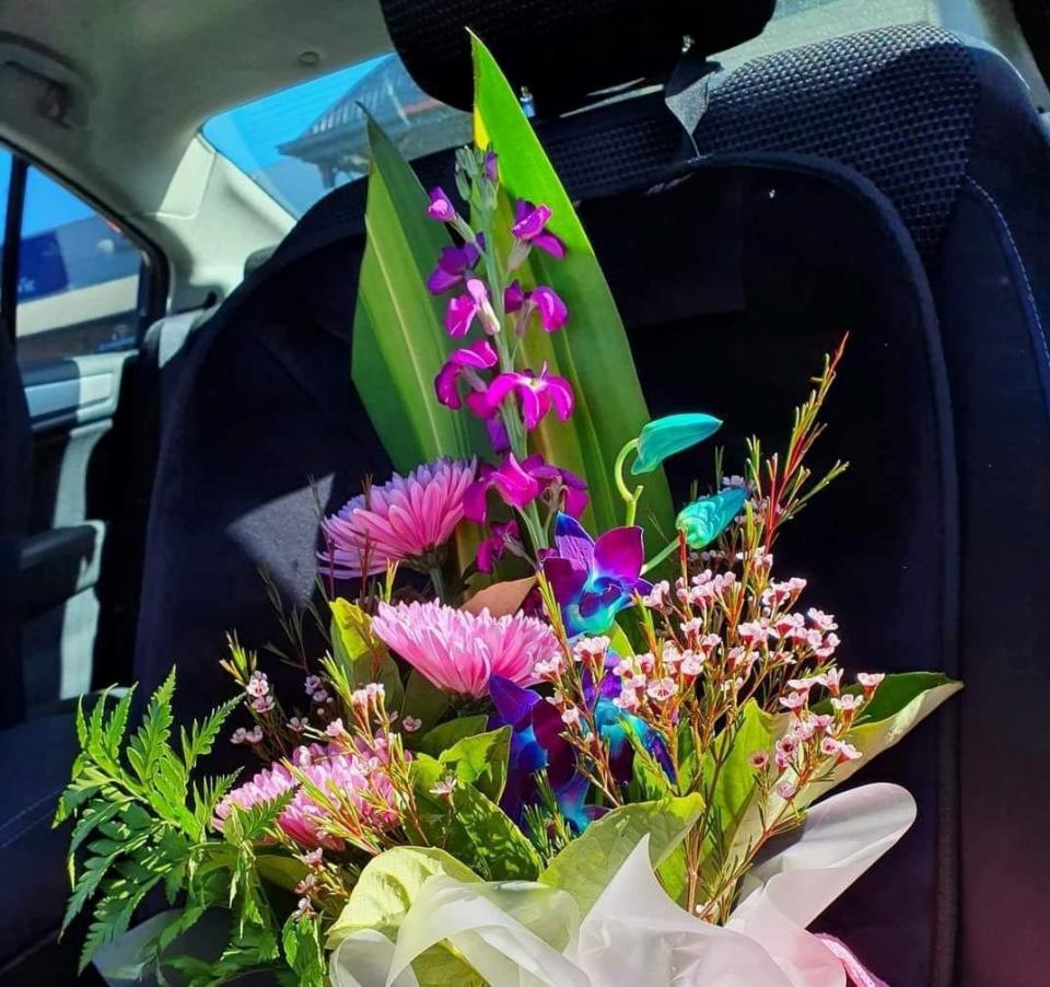 Bunch of flowers sitting on a car seat. Source: Facebook