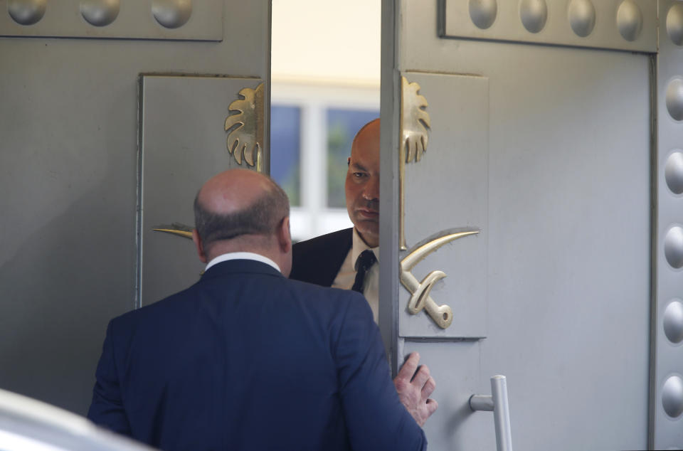 Men stand at the doors of the Saudi Arabia consulate in Istanbul, Monday, Oct. 8, 2018. Turkey has summoned the Saudi ambassador to request the kingdom's "full cooperation" in an investigation into the disappearance of journalist Jamal Khashoggi, who Turkish officials say was killed while visiting the Saudi Consulate in Istanbul. (AP Photo/Lefteris Pitarakis)