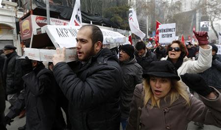 Demonstrators carry a mock coffin made of shoe boxes, as a reference to what the media said are shoe boxes of cash found in the house of Halkbank CEO Suleyman Aslan, during a demostration against Turkey's ruling Ak Party (AKP) and Prime Minister Tayyip Erdogan in Ankara December 21, 2013. REUTERS/Umit Bektas