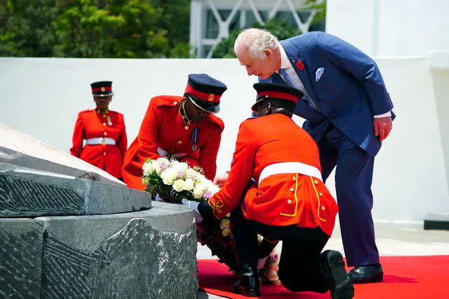 <p>Victoria Jones/Pool/Getty</p> King Charles lays a wreath at a ceremony at the tomb of the Unknown Warrior in Uhuru Gardens on October 31.