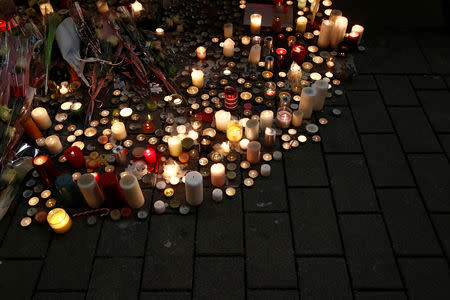 Candles burn in tribute to the victims of the deadly shooting in Strasbourg, France, December 13, 2018. REUTERS/Christian Hartmann