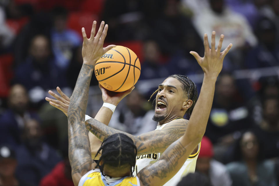 Grambling State guard Virshon Cotton, top, attempts to shoot against Southern University in the first half of an NBA All-Star HBCU classic college basketball game Saturday, Feb. 18, 2023, in Salt Lake City. (AP Photo/Rob Gray)