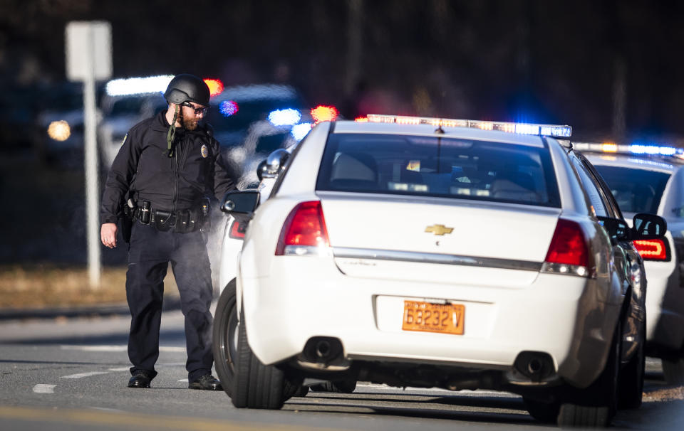 A police officer with the Winston-Salem Police Department responds to the Joycelyn V. Johnson Municipal Services Center after reports of gunshots in Winston-Salem, N.C. early Friday, Dec. 20, 2019. Winston- Salem Police are confirming there was a shooting but are not saying at this time if there are any injuries or deaths. (Andrew Dye/The Winston-Salem Journal via AP)