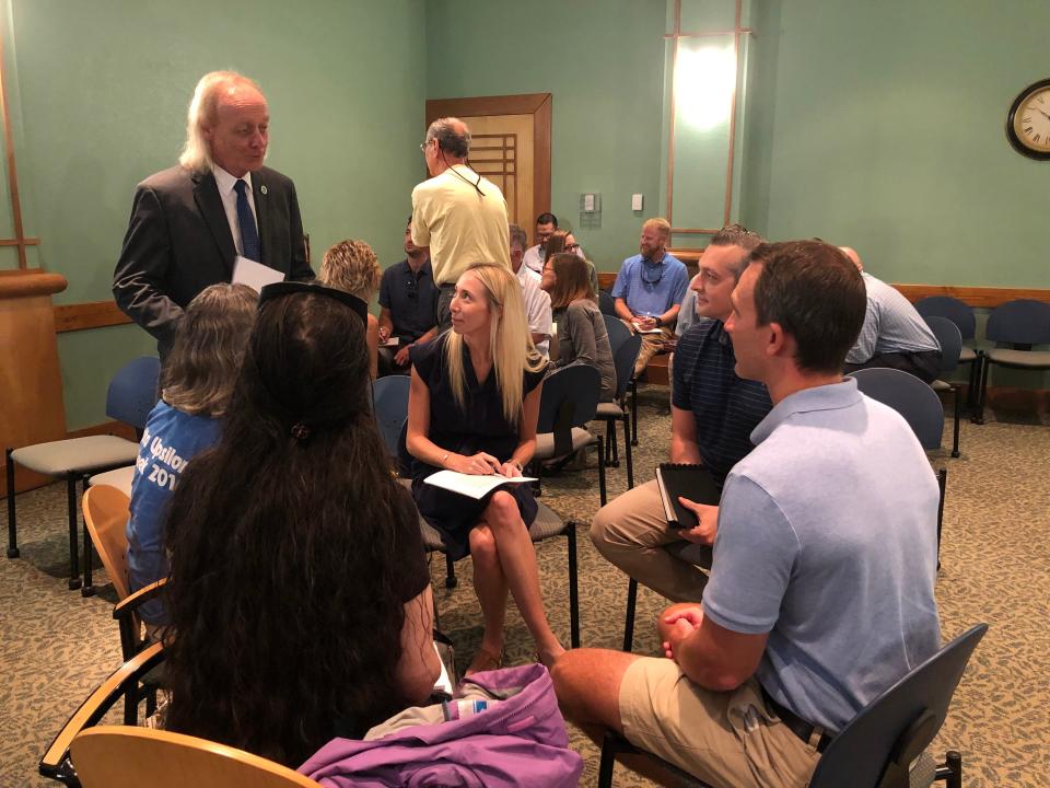 Walton County Planning Director Mac Carpenter (standing in foreground) speaks to people at a recent public workshop. Carpenter is interested in moving developers away from "buying out" requirements that they install sidewalks in their projects.