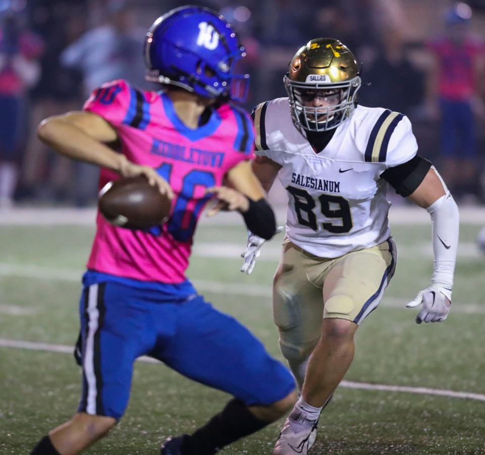 Salesianum's Nathaniel Ray closes in on Middletown quarterback Austin Troyer in the second quarter at Cavalier Stadium, Friday, Oct. 14, 2022.