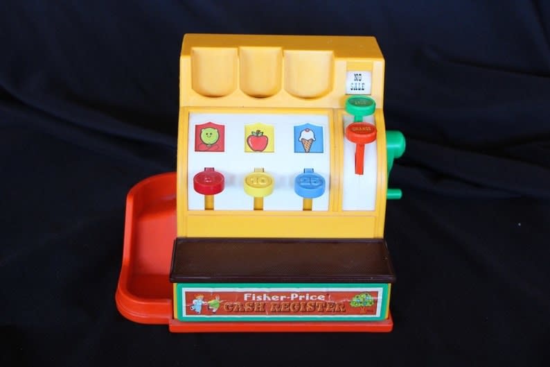 A yellow, brown, and orange toy register