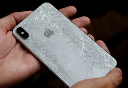 FILE PHOTO: A worker refurbishes an Apple Iphone cell phone at a workshop of the Oxflo company, specialised in refurbishment of broken European smartphones in Lusignac