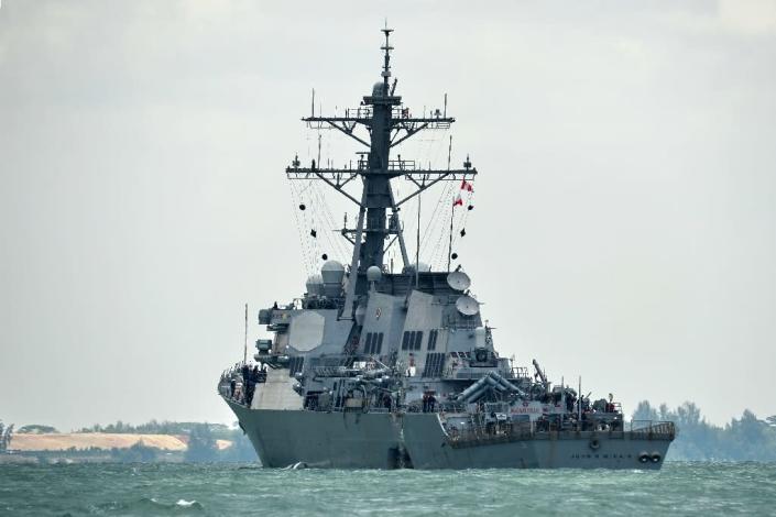 The USS John S. McCain with a hole on its portside after a collision with an oil tanker (AFP Photo/ROSLAN RAHMAN)