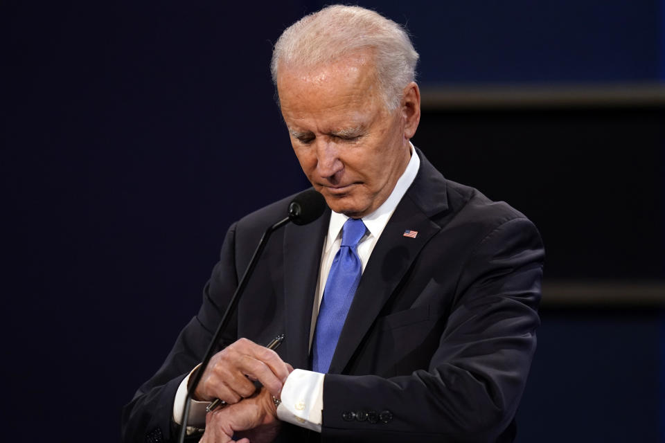 FILE - Democratic presidential candidate former Vice President Joe Biden checks his watch during the second and final presidential debate Oct. 22, 2020, at Belmont University in Nashville, Tenn., with President Donald Trump. (AP Photo/Patrick Semansky, File)