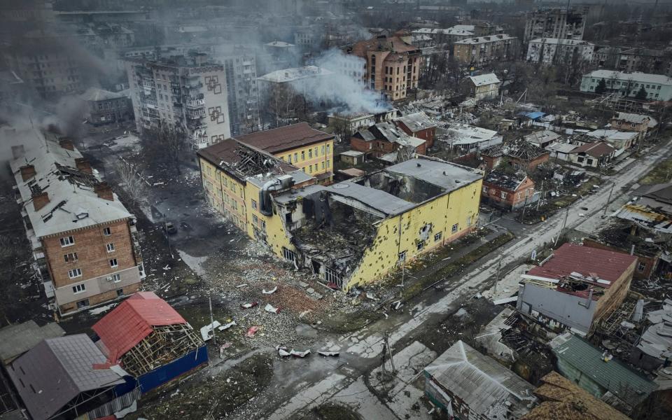 An aerial image shows one building destroyed and others smouldering after heavy battles in Bakhmut - AP Photo/Libkos