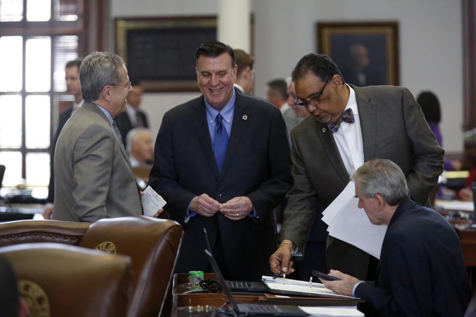 FILE - In this April 11, 2019 file photo Rep. Rick Miller, R-Sugar Land, talks with Rep. Paul Dennis, R-Houston, Joe Deshotel, D-Beaumont, and Rep. Ed Thompson, R-Pearland in the Texas House of Representatives chamber in Austin, Texas. Drowned out by the coronavirus and national politics, Republican and Democratic operatives are nonetheless quietly preparing for a battle of state legislative supremacy later this year that could have a profound effect on political power for the next decade to come. This week, national Republicans are rolling out their first offensive target list for the November state legislative elections. It’s focused on 115 Democratic-held seats in a dozen states where Republicans hope to strengthen their power or dent that of Democrats. (James Gregg/Austin American-Statesman via AP)