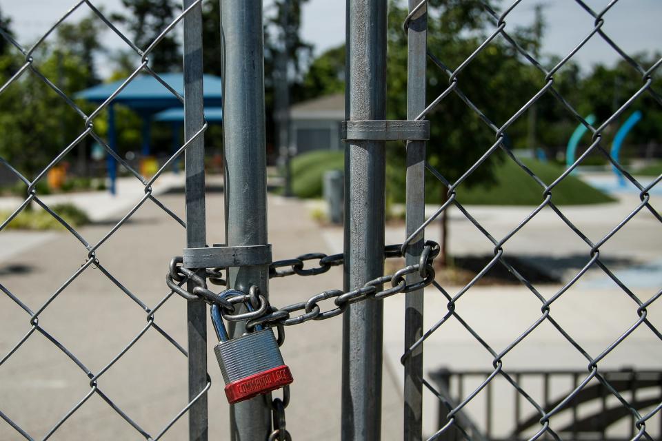 Brooklands Plaza Splash Pad in Rochester Hills is fenced off on Sunday.