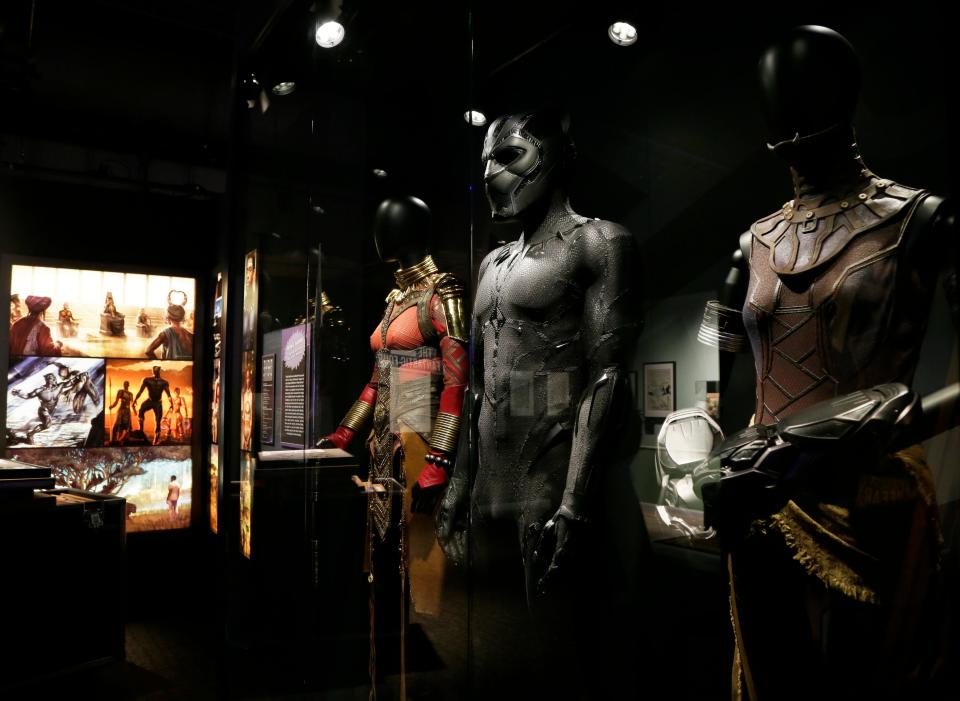 Costumes worn by Danai Gurira as Okoye, left, Chadwick Boseman as Black Panther, center, and Letitia Wright as Shuri, right, in the Marvel Studios' movie "Black Panther," released in 2018, will be on display at COSI with the "Marvel: Universe of Super Heroes" exhibit.