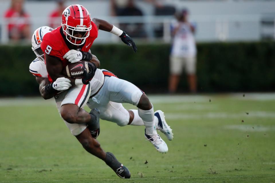 Georgia Bulldogs wide receiver Jackson Meeks (9) is stopped by Auburn Tigers linebacker Owen Pappoe (0) during the second half of a NCAA college football game between Auburn and Georgia in Athens, Ga., on Saturday, Sept. 8, 2022. Georgia won 42-10.