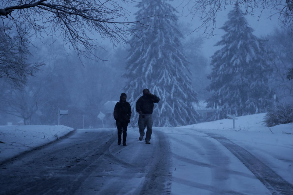 <p>A family walks down a snowy street during a winter storm, Friday, March 2, 2018, in Marple Township, Pa. (Photo: Matt Slocum/AP) </p>